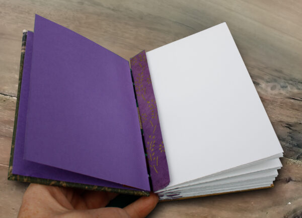 Askham Fields Hand bound coptic, open with purple endpapers