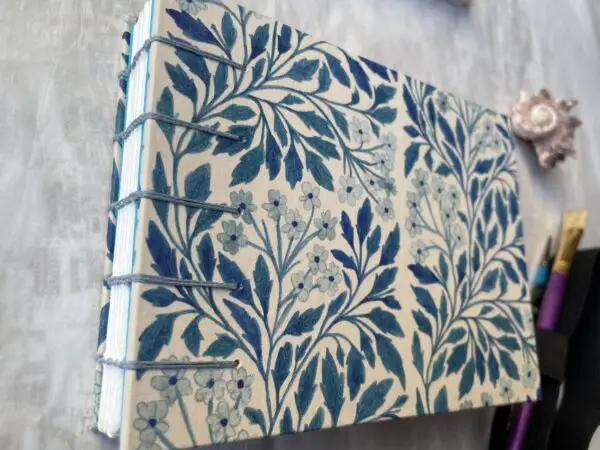 Blue Floral watercolour sketchbook showing coptic spine